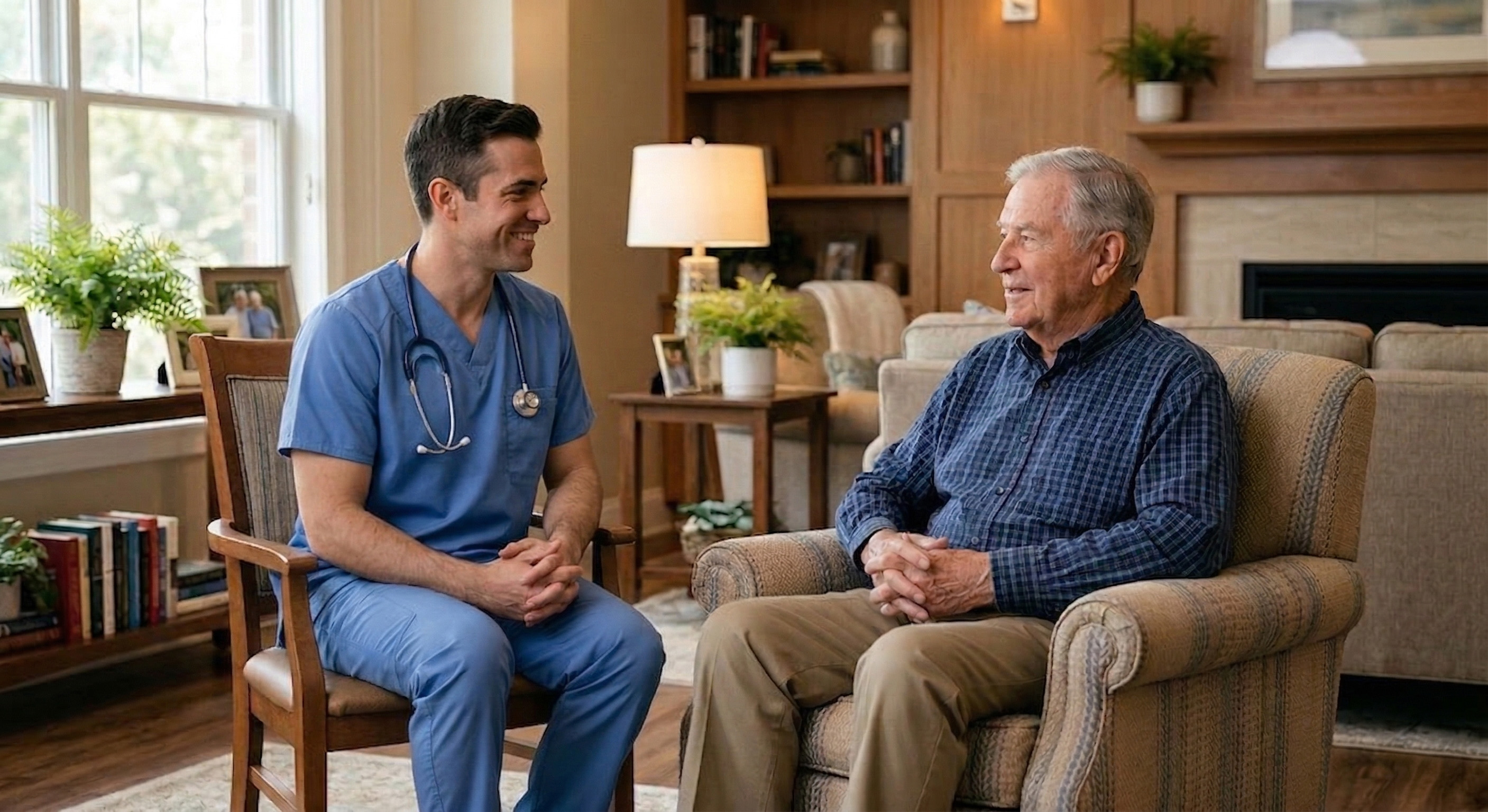 Healthcare provider showing a senior resident information on a tablet in a cozy living room